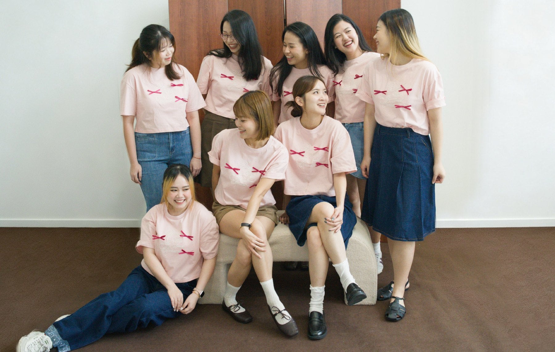 The SHOPLOOOH team laughing together in the pink Being Alive Is the Special Occasion Tee