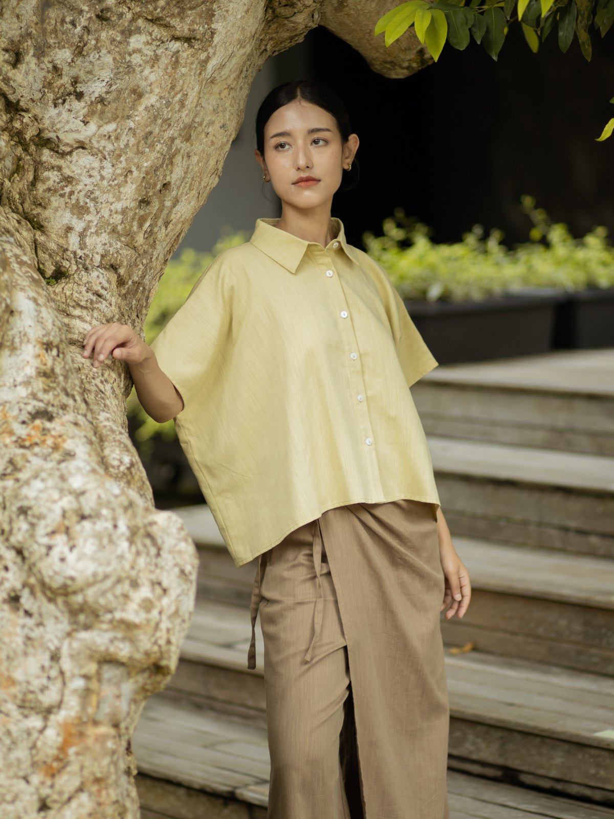 SHOPLOOOH Re Collection botanical yellow shirt with warm brown wrap trousers, by an old tree
