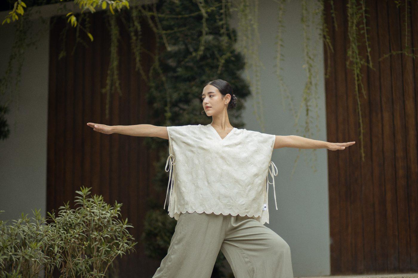 Warrior pose in the SHOPLOOOH Re Collection embroidered scallop top and soft sage trousers