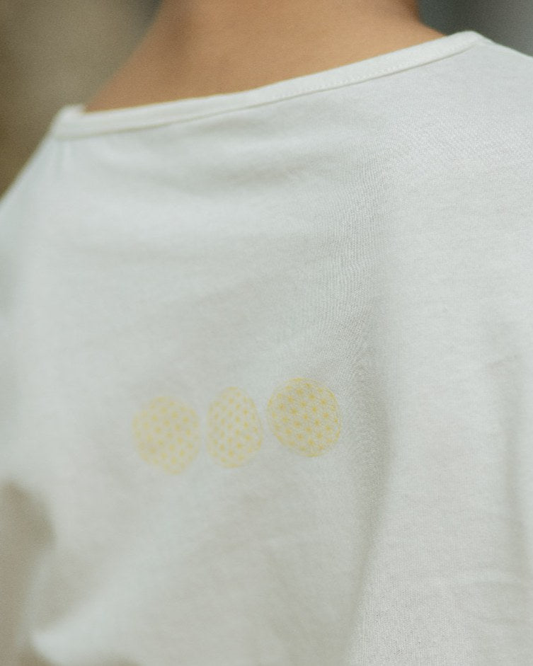 Flower of Life print on the back of a SHOPLOOOH Re Collection tee