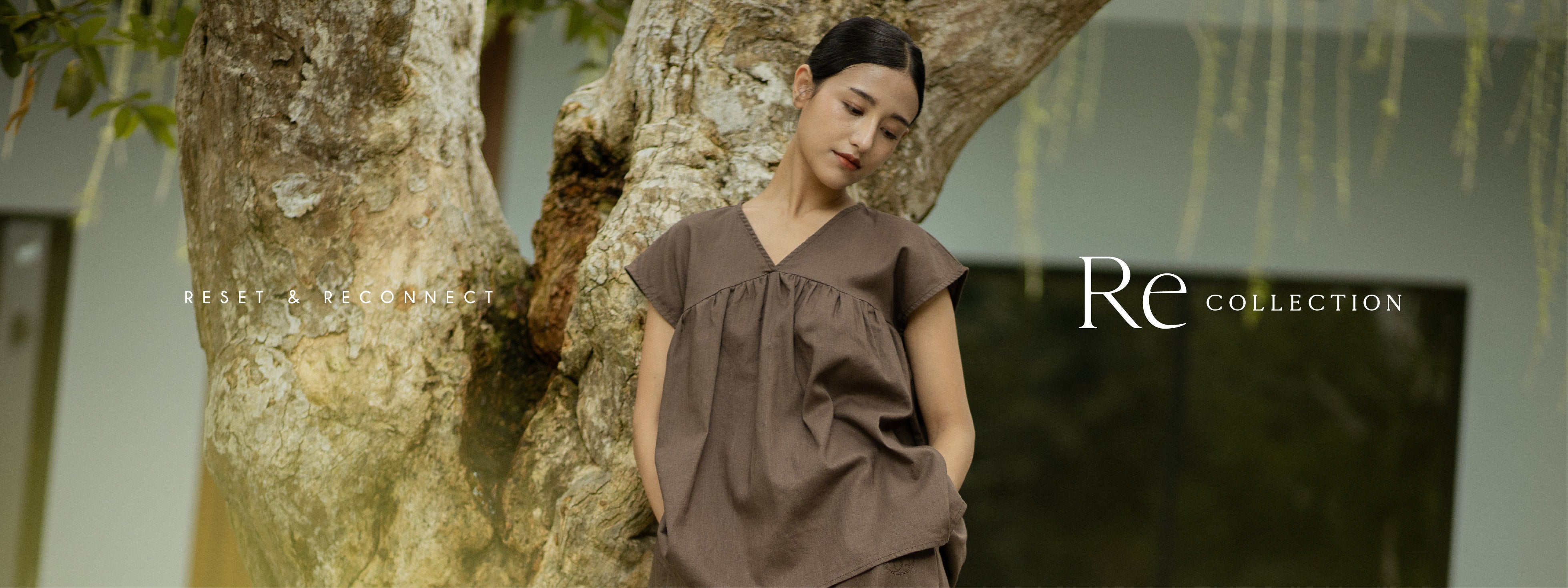 Re Collection — Reset & Reconnect. Leaning against an old tree in the SHOPLOOOH warm brown cotton-linen set