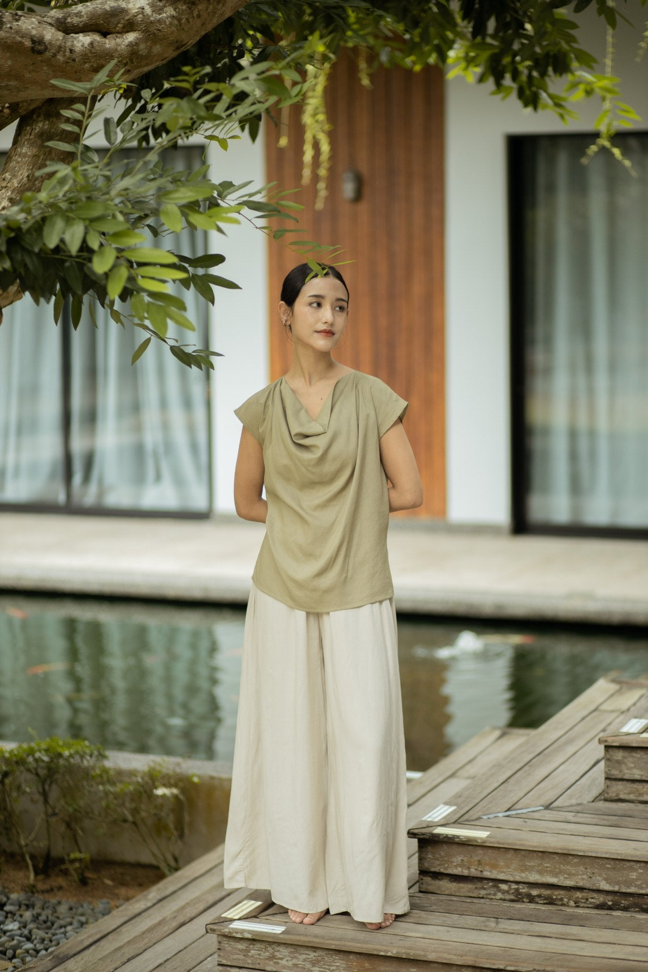 SHOPLOOOH Re Collection sage cowl-neck top and natural white trousers by the pond