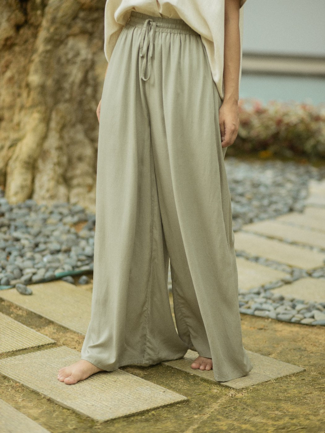 The SHOPLOOOH Re Collection soft sage wide trousers, worn
