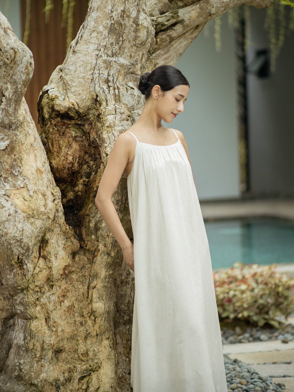 SHOPLOOOH Re Collection natural white cotton-linen camisole dress, leaning on an old tree